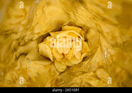 Potato chips with salt inside foil bag package Stock Photo