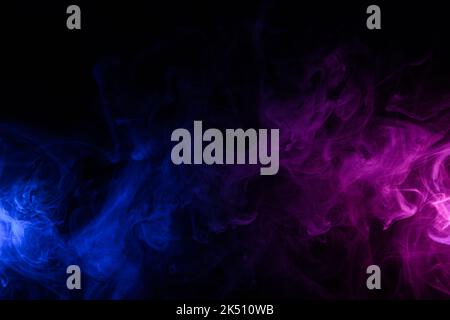 Flowing clouds of colorful swirling blue and purple neon smoke dark abstract background Stock Photo