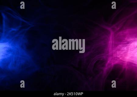 Clouds of colorful blue and purple smoke dark abstract background Stock Photo