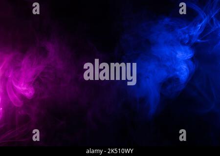 Waves of neon swirling blue and purple smoke dark abstract background Stock Photo