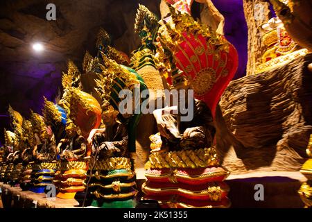 Ancient hermit or antique eremite statues with naka guardian for thai people travelers travel visit and respect praying blessing holy worship mystery Stock Photo