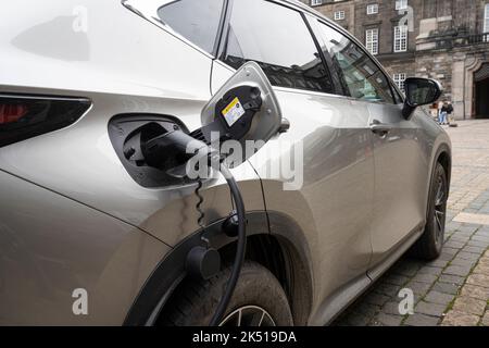 Copenhagen, Denmark. October 2022. an electric car being recharged in the city center Stock Photo