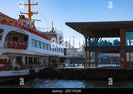 Travel to Istanbul. Ferry near the Karakoy Pier and Suleymaniye Mosque on the background. Istanbul Turkey - 9.30.2022 Stock Photo