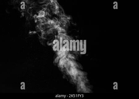 curly white steam and splashing water splashing isolated on black background. Abstract background, design element. Evaporation of liquid and condensat Stock Photo