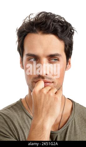 Scheming about something. A handsome young man looking pensive. Stock Photo