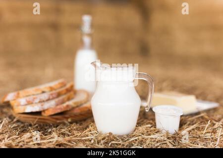 Rustic breakfast of milk, fresh wheat bread and butter in the hayloft Stock Photo