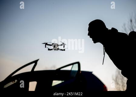 A man silhouette yelling at the drone Stock Photo