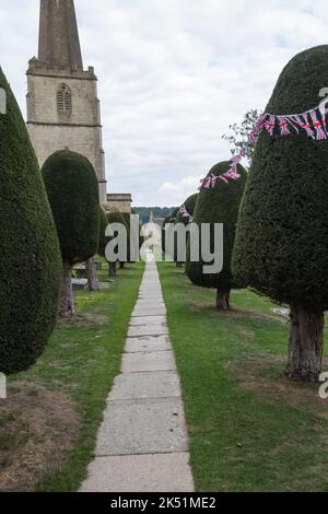 The churchyard at St. Mary's Church in Painswick, Gloucestershire is famous for its yew trees Stock Photo