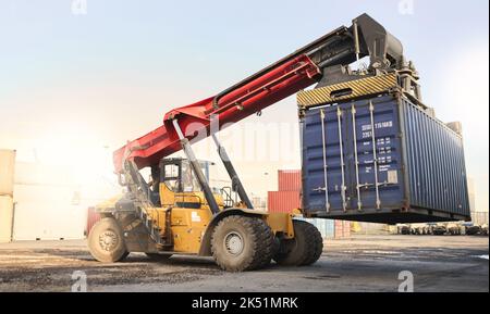 Transport, logistics and supply chain with container storage and a crane vehicle on a commercial dock. Shipping, cargo and freight in an empty yard Stock Photo