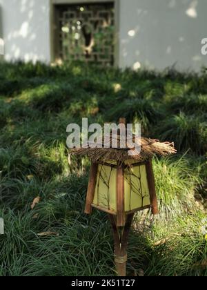 A vertical shot of a garden light installed on the grass of a garden Stock Photo