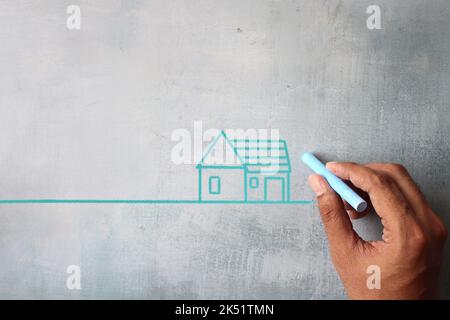 Top view image of hand drawing house on chalkboard with copy space.  Real estate, property concept Stock Photo