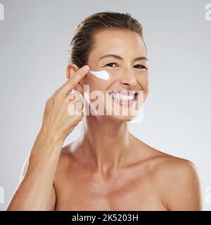 Portrait of woman in skincare, beauty and skin products with lotion on her face. Mockup up for natural beauty, beauty products and anti aging cream Stock Photo