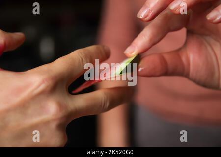 Defocus female hand holds watermelon slice and give it to man. Colorful hot summer holidays. Close up slices of watermelon in hands. Togetherness and Stock Photo