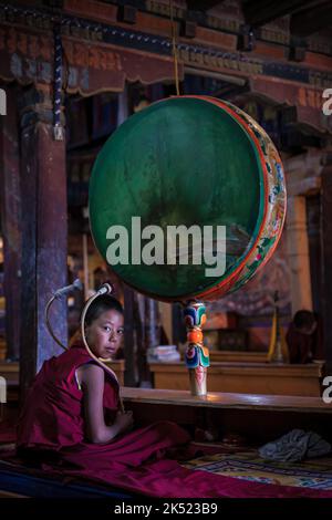 A young monk with a drum at  Thikse Monastery (Thiksay Gompa), Ladakh, India Stock Photo