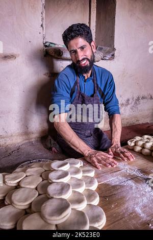 A man preparing dough for bread in Leh, Ladakh, India Stock Photo
