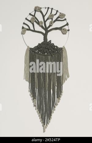 Hand woven black macrame with white beads hanging on wall Stock Photo -  Alamy