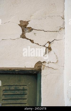 A wall cracked, above a door. Stock Photo
