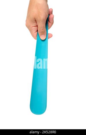 Shoe spoon in hand, on a white background Stock Photo