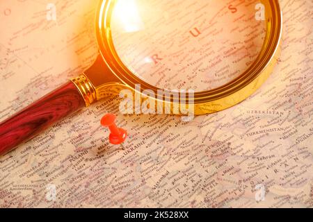 Magnifying glass and red button on map pointing to territory Ukraine Stock Photo