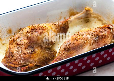 baked goose legs with cumin in frying pan Stock Photo