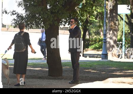 Catrinel Marlon (R) and companion Massimiliano Di Lodovico (L) walk