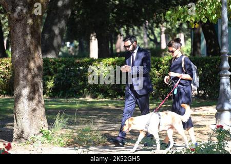 Catrinel Marlon (R) and companion Massimiliano Di Lodovico (L) walk