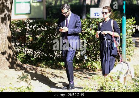 Catrinel Marlon (R) and companion Massimiliano Di Lodovico (L) walk