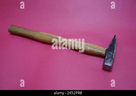 old vintage hammer isolated on red background Stock Photo