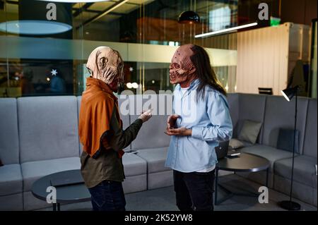 Zombie coworkers speaking together in office Stock Photo