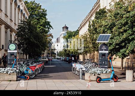 Electric bicycles, City Bicycle in street. Sharing electrical bikes. Shared cars, bicycles and scooters and solar charging station Warsaw, Poland - Stock Photo