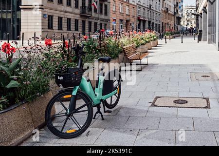 Bolt Electric bicycles, City Bicycle Bolt in street. Sharing electrical bikes. Shared cars, bicycles and scooters Warsaw, Poland - September 02, 2022 Stock Photo