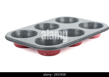 Soft focus on metal muffin tin over white background. Copy space. Stock Photo