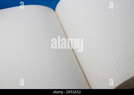 Close-up of a white page notebook with squares opened by a random pages Stock Photo