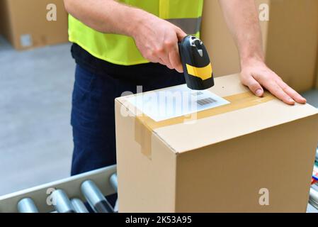 workers in the warehouse scanning parcels for retail and transport shipping Stock Photo