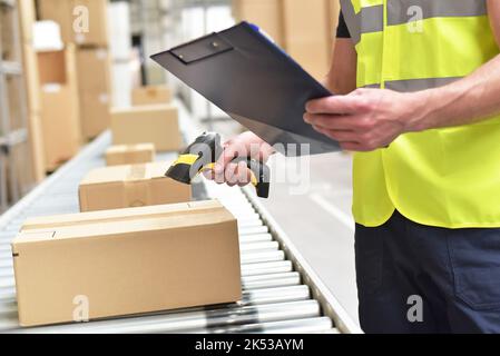 workers in the warehouse scanning parcels for retail and transport shipping Stock Photo