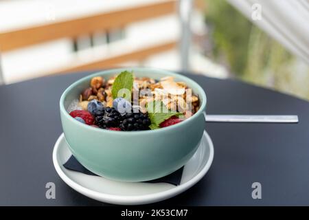 eating chia pudding with nuts and berries Stock Photo