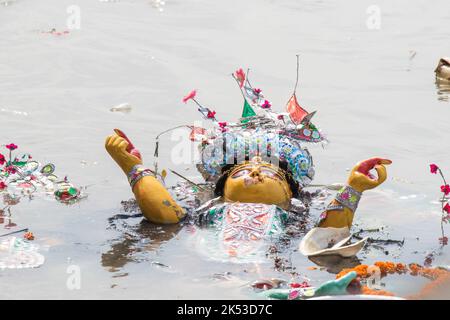 Idol of Goddess Durga is being immersed at holy river Ganges, at the end of Durga Puja festival. The event is called Bisorjon in Bengali language. Stock Photo