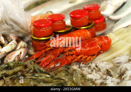 A stall with goods in the fish market. Fresh fish, shellfish and caviar close-up Stock Photo