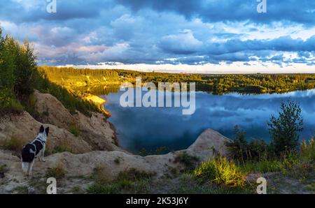 Sunset in the cloudy sky over the Pugorevsky quarry. Vsevolozhsk. Leningrad Region Stock Photo