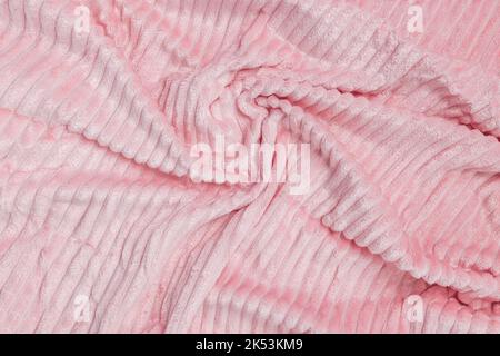 New soft pink fabric. Abstract texture background with waves and lines. Top view, closeup Stock Photo
