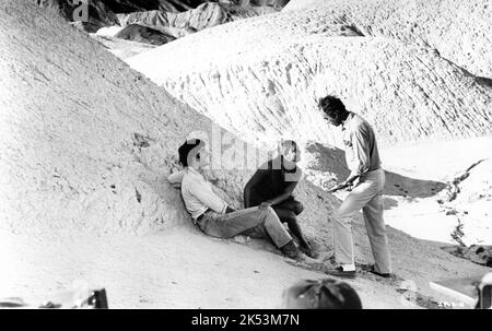 MARK FRECHETTE and DARIA HALPRIN on set location candid with Director MICHELANGELO ANTONIONI during filming in Death Valley of ZABRISKIE POINT 1970 director / story MICHELANGELO ANTONIONI music Jerry Garcia and Pink Floyd producer Carlo Ponti Metro Goldwyn Mayer Stock Photo