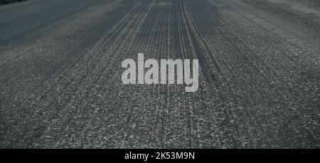 Old asphalt. Budget repair of the road. Broken asphalt in the forest. banner Stock Photo