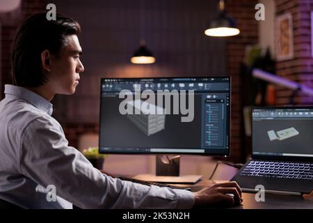 Cad developer working on industrial manufacture of technical engine product with infographics interface. Developing machinery component with engineering manufactory for science development. Stock Photo