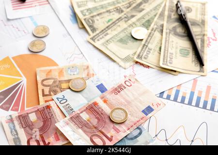 Different banknotes with coins and diagrams on virtual screen. Exchange ...