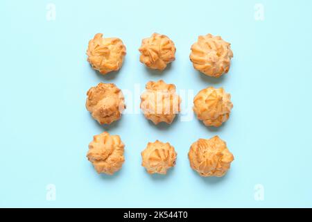 Composition with delicious eclairs on color background Stock Photo
