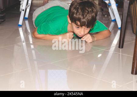 Portrait of a child playing downstairs on a ladder. Skill at home. Salvador, Bahia, Brazil. Stock Photo