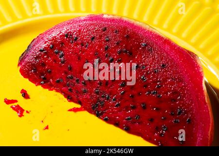 pink pitaya on a yellow plate Stock Photo