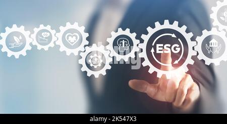 ESG concept of environmental, social and governance. Sustainable corporation development. Businessman touching on ESG with other ESG icons; environmen Stock Photo