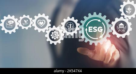 ESG concept of environmental, social and governance. Sustainable corporation development. Businessman touching on ESG with other ESG icons; environmen Stock Photo