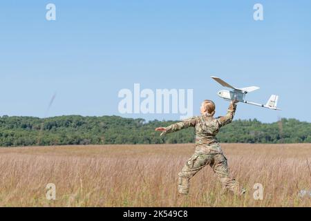 Wisconsin National Guard Soldiers flying RQ-11B Raven Small Unmanned Aircraft System (SUAS) over Badger drop zone as part of a two week additional skills course taught by Wisconsin Military Academy instructors at Fort McCoy WI. Stock Photo